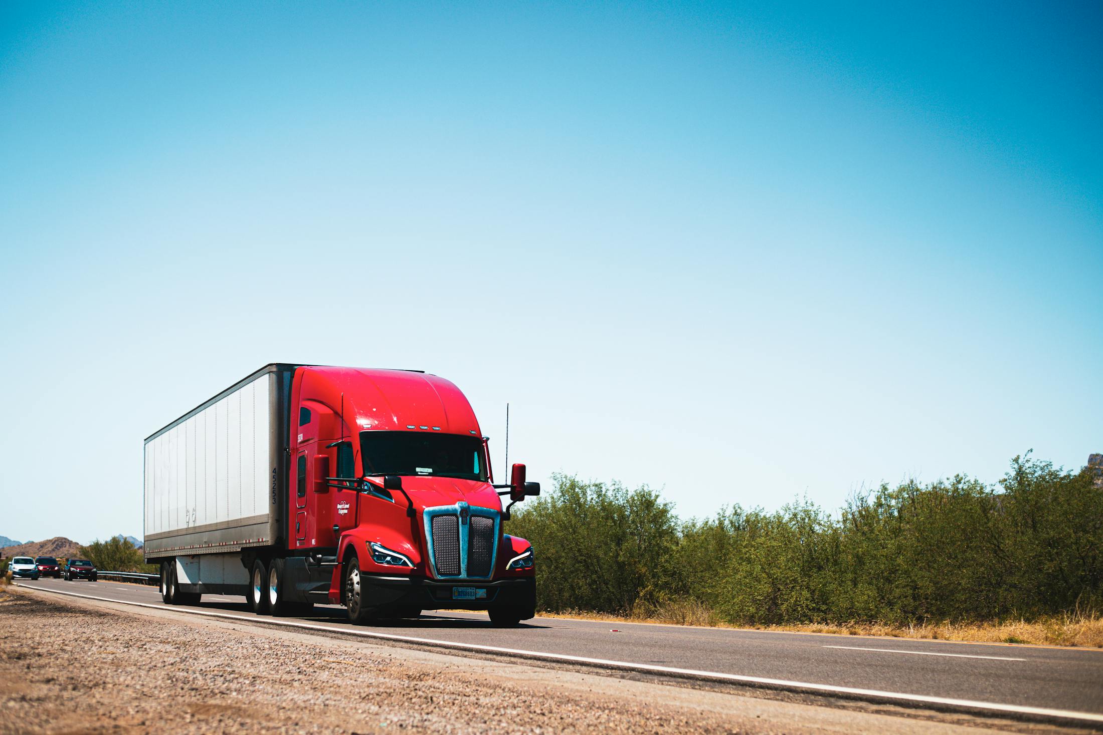 Modern American semi truck hauling a trailer on a highway
